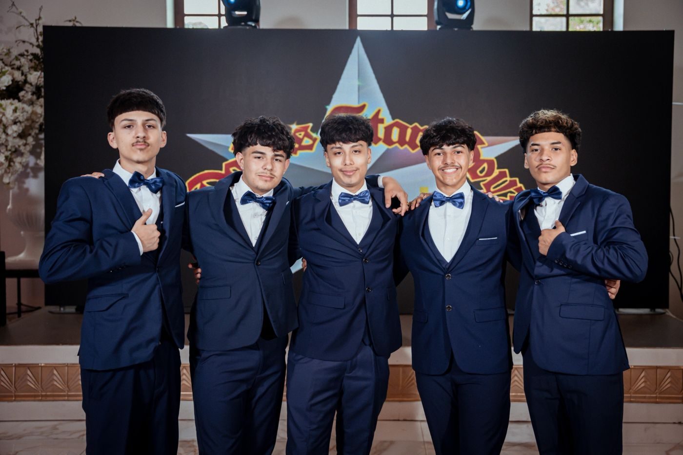 Dallas Star Boyz cadets in navy tuxedos with the quinceañera