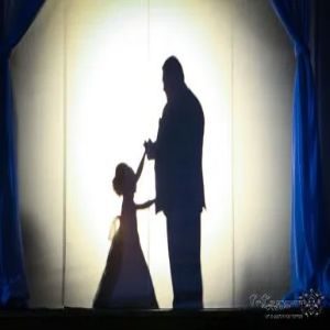 Shadow dance silhouette behind a lit screen